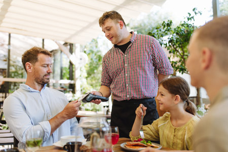 Man paying for lunch in a restaurant by card.