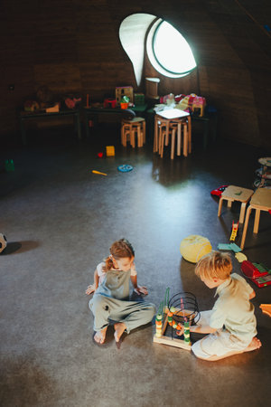 Children are playing together in indoor play area at a restaurant.の写真素材