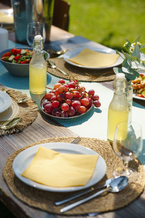 Close up shot of a set table at a summer garden party.の写真素材