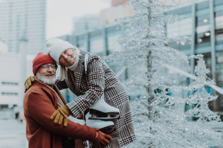 Portrait of seniors in winter at outdoor ice skating rink.の写真素材