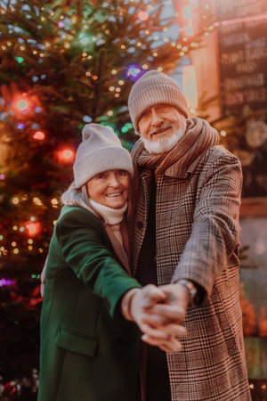 Happy senior couple enjoying christmas market.の写真素材