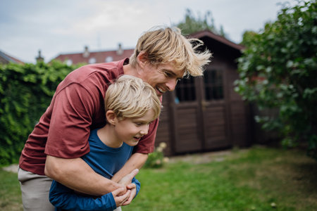 Father embracing his young son, having bonding moment. Concept of Fathers Day, and fatherly love.の写真素材
