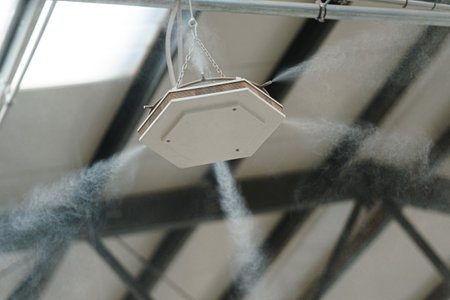 Industrial dust control system in modern manufacturing factory. Dust suppression with water mist,...