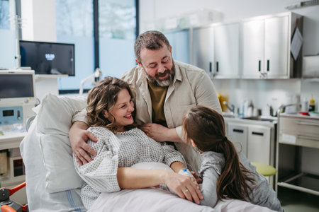 Father and daughter visiting mother in hospital after surgery. Emotional support from family for patients in hospital.の写真素材