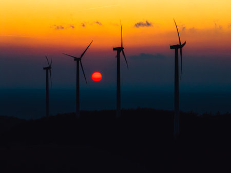 Aerial landscape photography of sunrise over nature with wind turbines. Windmill in soft morning...