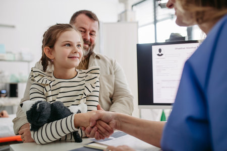 Doctor greeting young girl patient. Concept of children healthcare and emotional support for child...