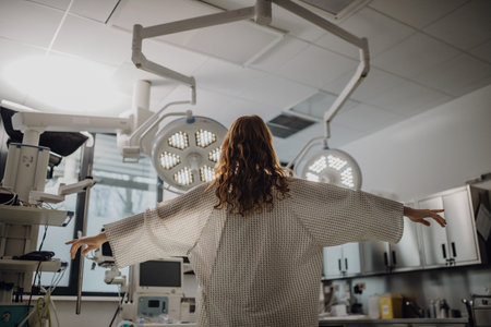 Rear view of patient in hospital gown in emergency room. Looking like angel.