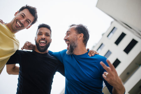 Best friends playing sport outdoors, having fun, competing. Playing basketball at a local court,...