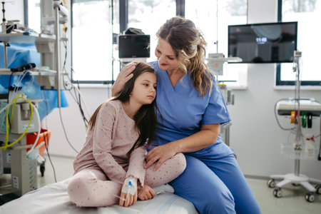 Supportive doctor soothing a worried children patient in emergency room. Hugging little girl before...