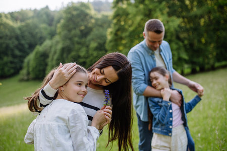 Beautfiul young family at meadow, enjoying together time.の写真素材