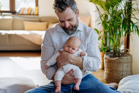 Father holding his newborn baby. Unconditional paternal love, Fathers Day concept.