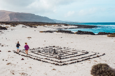Siblings on walk at Canary islands beach. Concept of family beach summer vacation with kids.