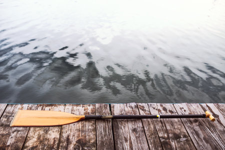 Paddle on wooden dock. Concept of canoeing as dynamic and adventurous sportの写真素材