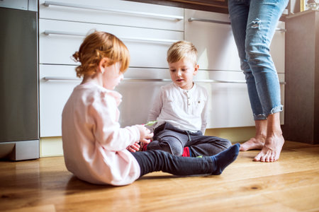 Grandma takes care of the grandchildren while their parents are at work, helping with the little kids.の写真素材