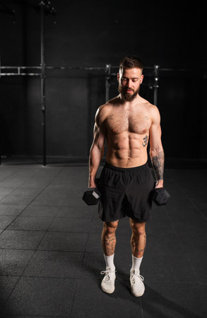 Man performing dumbbell lunge, holding dumbells in both hands. Routine workout for physical and...