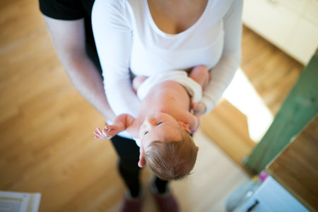 New parents holding newborn baby girl. Unconditional paternal love, idyllic family moment.の写真素材