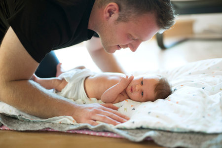 Father looking at his newborn baby. Unconditional paternal love, Fathers Day concept.の写真素材