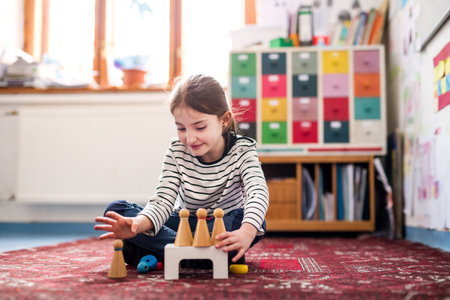 Portrait of schoolgirl using educational tool, learning while playing. Student girl in classroom at the elementary schoolの写真素材