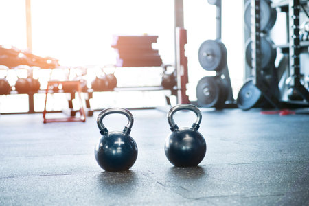 Kettlebells on floor in gym. Gym equipment for strength training.の写真素材