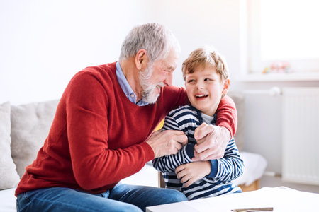 Grandfather spending time with grandson, taking care of him while parents are at work. Having fun.