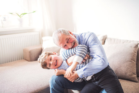 Grandfather spending time with grandson, taking care of him while parents are at work. Having fun.