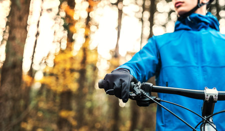 Close up of cyclist on bike in the middle of beautiful nature during early autumn morning. Concept of healthy lifestyle.の写真素材