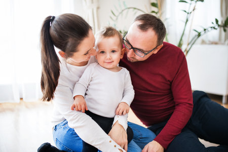 Family portrait. Young happy nuclear family with small toddler boy.