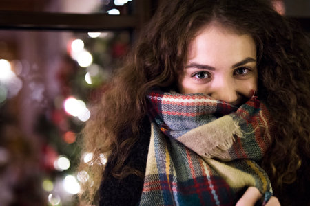 Student is coming home from university for the Christmas holidays, standing in front of house...