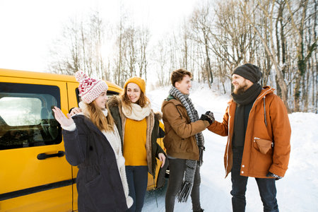 Friends arrived at winter cabin after long ride in car. Spending Christmas, winter holiday in cabin.
