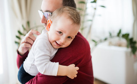Portrait of father with little son. Dad holding little boy and hugging him.の写真素材