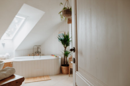 Modern attic bathroom with a bathtub and water toys.の写真素材