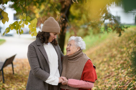 Portrait of a granddaughter on an autumn walk in the park with her grandmother.の写真素材