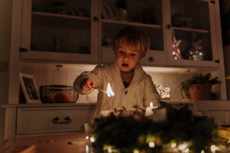 Little boy lighting candles on advent wreath.の写真素材
