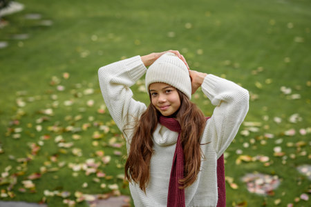 Outdoor portrait of cute young girl with beanie and thick sweater.の写真素材