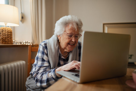 Senior woman working on laptop on her own, feeling confident.