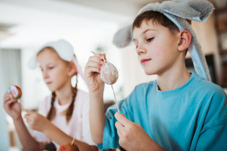 Girl and boy paiting eggs for easter.の写真素材
