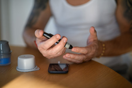 Person checking their blood sugar at home.