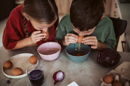 Siblings preparing egshells for easter egg decorating.の写真素材