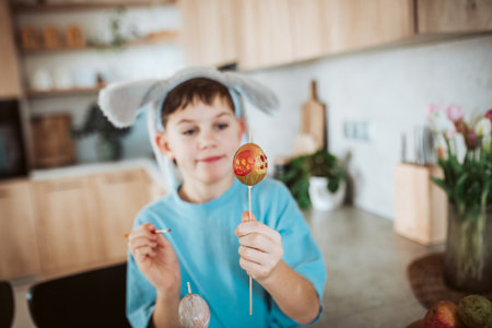 Smiling boy paiting eggs for easter.