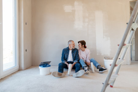 Senior couple renovating their home, a shared retirement activity.の写真素材