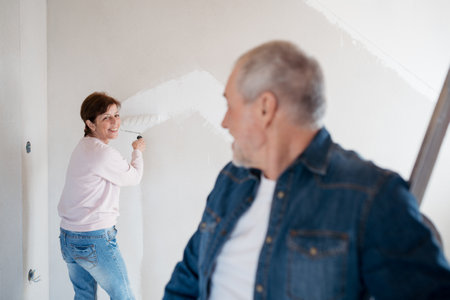 Senior couple renovating their home, a shared retirement activity.の写真素材