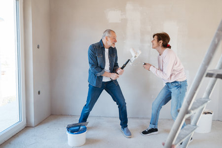 Senior couple renovating their home, a shared retirement activity.の写真素材