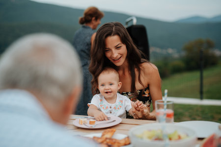 Portrait of cute baby girl during spring outdoor barbecue.の写真素材