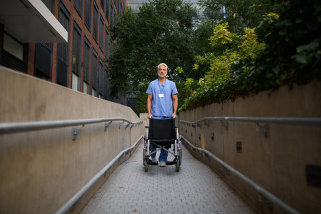 Portrait of male caregiver pushing wheelchair.