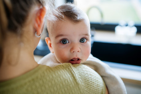 Big sister taking care of baby brother.の写真素材