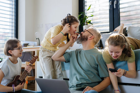 Father with three daughters trying to work from homeoffice.