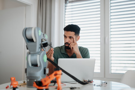 Engineer struggling with a technical problem while building robotic arm.の写真素材