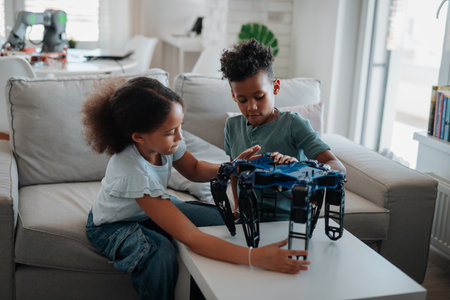 Kids building their first homemade robot at home.の写真素材