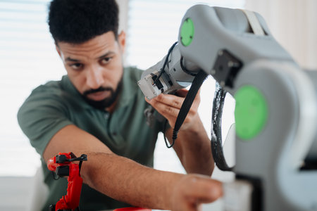 Young innovator developing robotic arm as part of home tech project.の写真素材