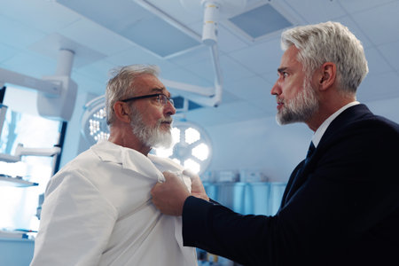 Aggressive man have conflict with doctor, holding him by coat.